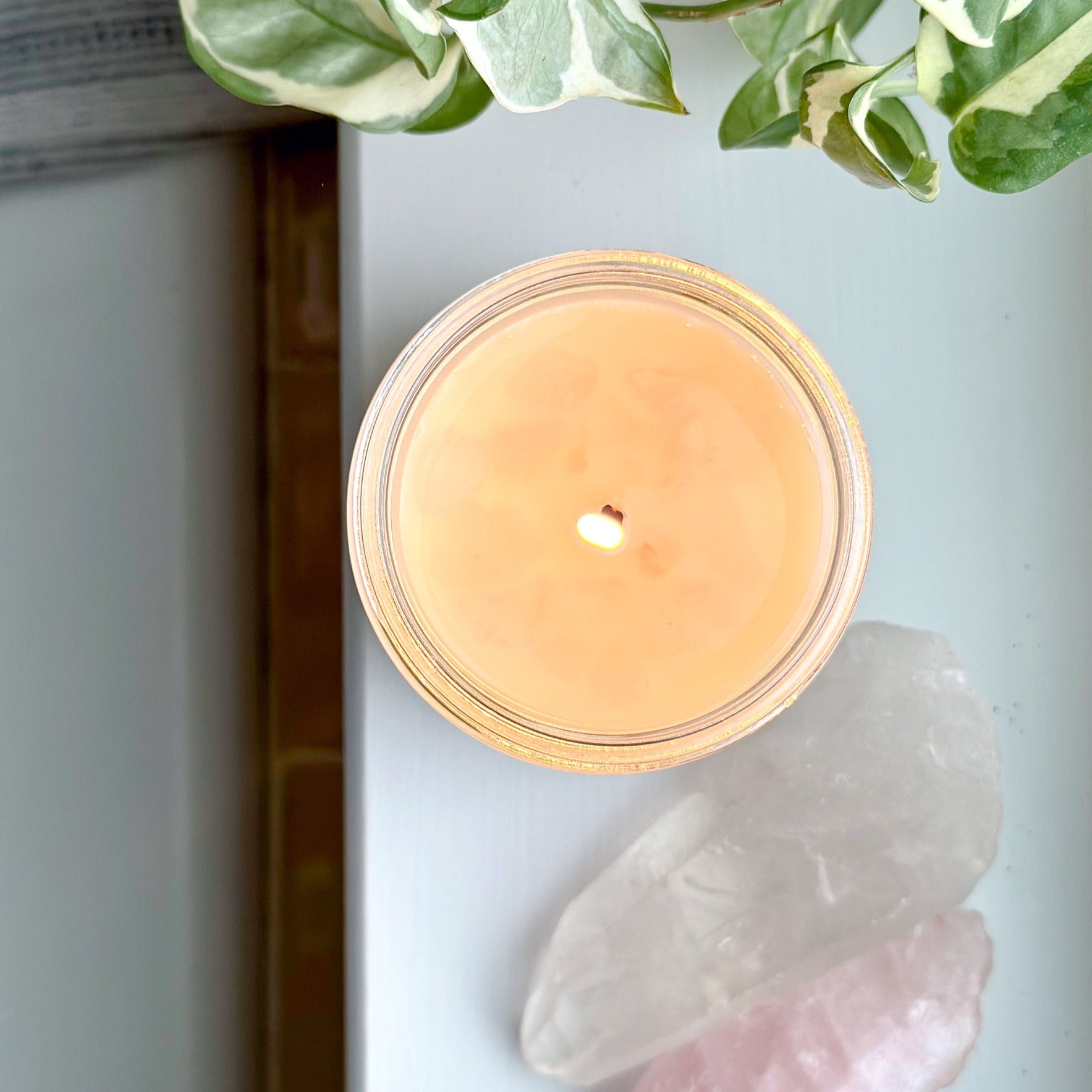 Love Spell candle by Slow North in a serene setting, perfect for relaxation with its non-toxic eucalyptus and lavender aroma and rose quartz accents.