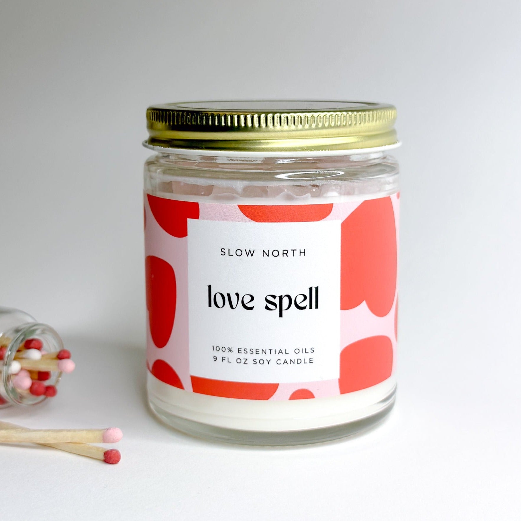 Close-up view of Slow North's Love Spell candle, highlighting the natural soy wax, eucalyptus and lavender aroma, and embedded rose quartz chips.