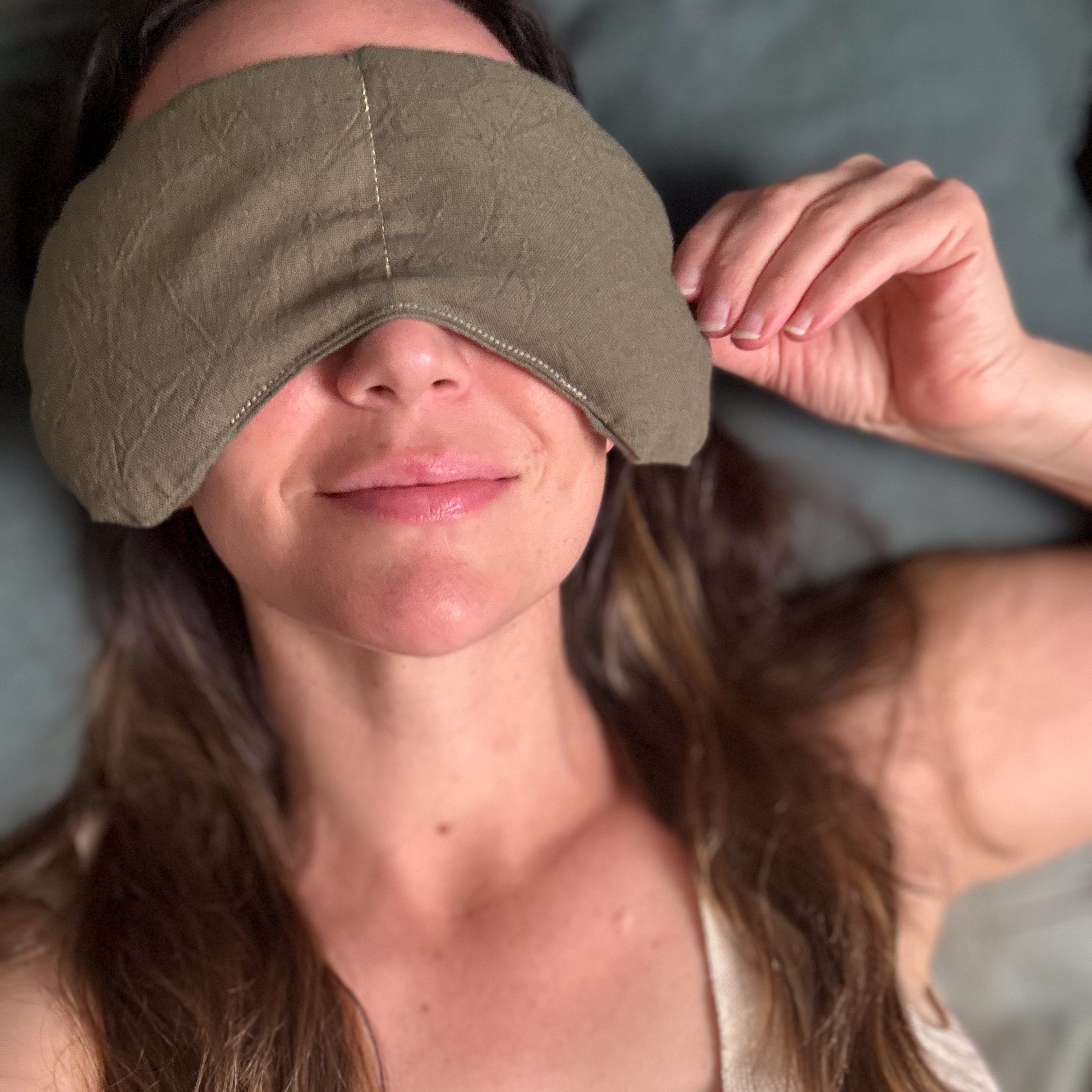 Woman relaxing with weighted eye mask